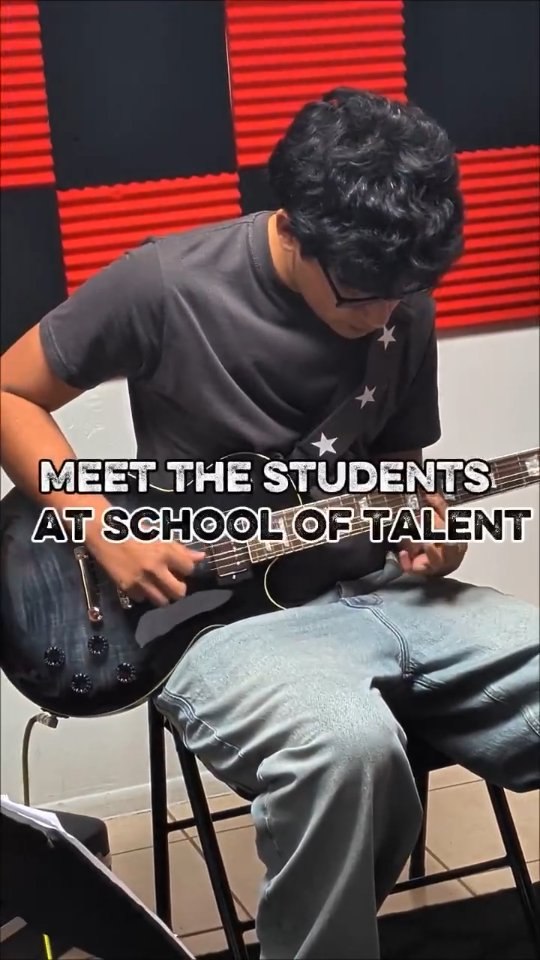 Luis playing guitar in a School of Talent student spotlight